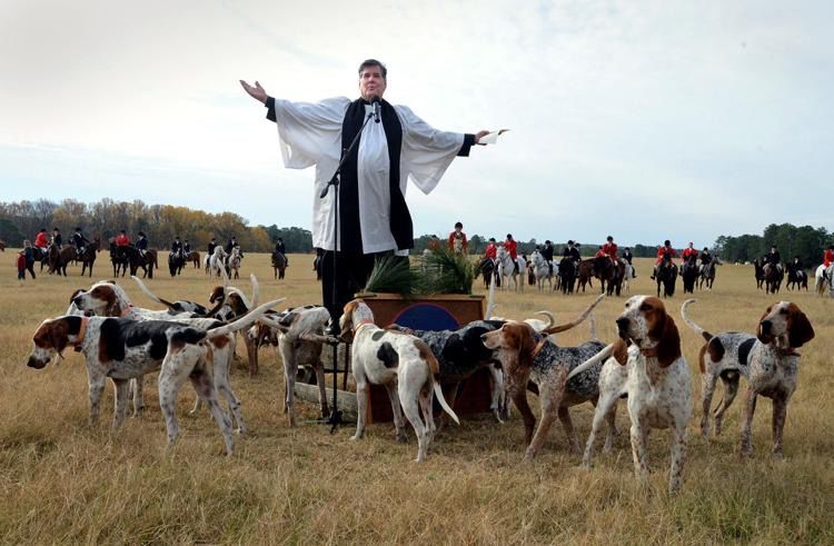 A priest officiates the Blessing of the Hounds at Buchan Field